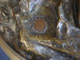 a close up of a bronze statue of a person