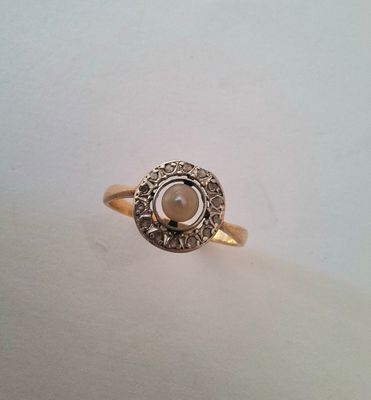 a close up of a gold ring with a stone in the center