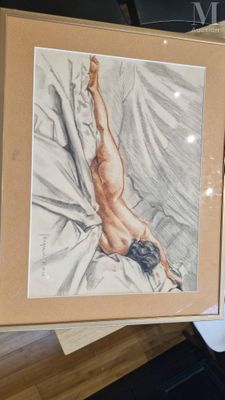 someone is holding a picture of a naked man in a box