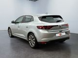 the rear end of a silver car in a white room