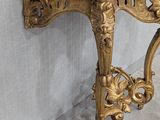 a marble table with a gold frame and a marble top