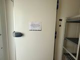 an image of a refrigerator in a small room