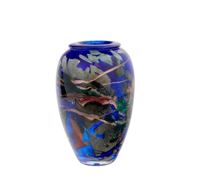 a blue vase with leaves on it on a white background