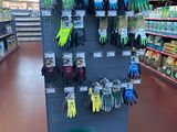 a display of gardening gloves and gardening gloves in a store
