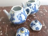 three small blue and white teapots sitting on a table