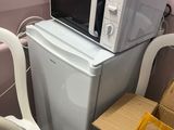a microwave and a washing machine stacked on top of each other