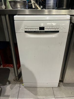 a white dishwasher sitting in the middle of a kitchen