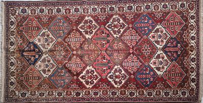 a red and blue rug with a diamond design on it