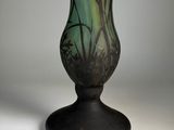an image of a green glass vase sitting on top of a table