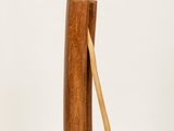 a tall wooden vase with a toothbrush sticking out of it