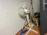 a fan that is sitting on the floor next to a door