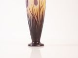 a vase that has a flower in it on a table