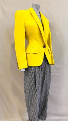 a mannequin wearing a yellow jacket and grey pants