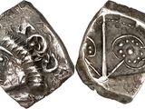a close up of two silver coins on a white surface
