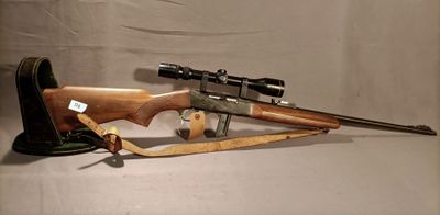an old rifle with a wooden barrel and scope on a white background