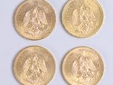 four different types of gold coins are shown on a white surface