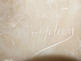 a close up of a marble sculpture with writing on it
