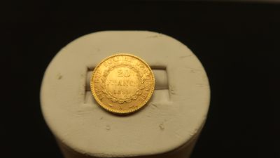 a gold coin sitting on top of a white object