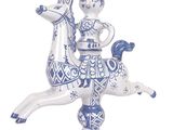 a blue and white figurine of a woman riding a horse