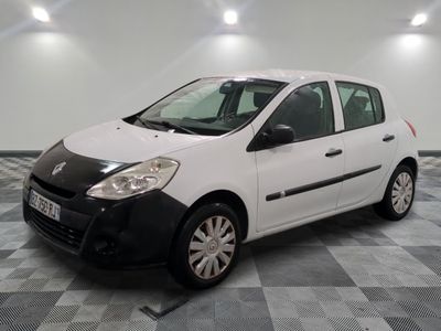 a picture of a small white car parked in a garage