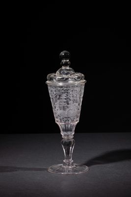 a close up of a glass container on a table with a black background