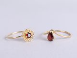 a pair of gold rings with garnets and garnets on them