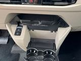 the interior of a car with a cup holder in the center of it
