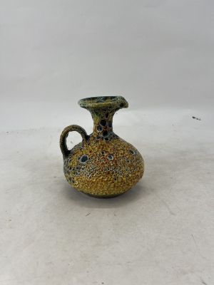 a small vase that is sitting on a white surface