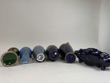 several different types of vases are lined up on a white surface