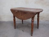 a small table with a wooden top on a concrete floor