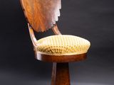 a wooden chair with a yellow seat and a black background