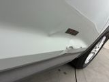 a close up of a white car with a sticker on the side of it