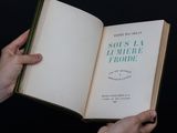 a person holding an open book in their hands
