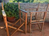 a table and chairs on a patio with a potted plant