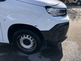 the white van is parked on the side of the road in the parking lot