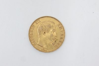 a close up of a gold coin with a man ' s face on it