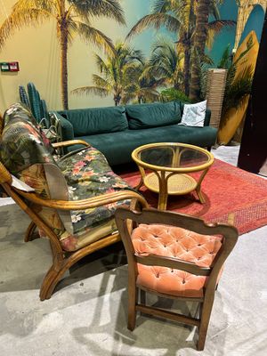 a living room with a couch, chair, table, and surfboard
