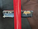 a close up of a red pole in a gym