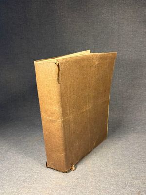 an open brown book sitting on top of a gray surface