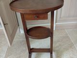 a small table with a shelf on it in a kitchen