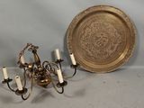 a gold plate and a chandelier with candles on it