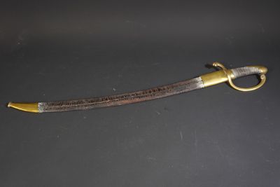 a close up of a knife on a table with a black background