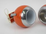 two orange and silver metal objects on a white surface