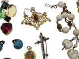 many different types of jewelry on a white surface