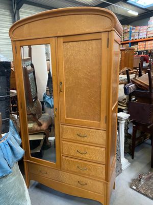 a wooden armoire with a mirror on top of it