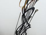 a metal sculpture of musical notes on a white wall