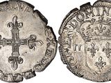 a silver coin with a cross on the front and a crown on the back