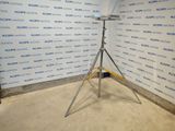 a camera on a tripod in front of a wall