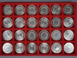 a red tray filled with silver coins on top of a table