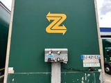 a green truck with a yellow z on the side of it